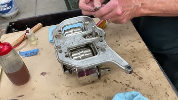 2517.  Connecting the Brunswick Phonograph top casting to the spring barrels. ￼