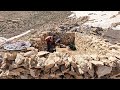 Making a traditional oven from stone and soil by a nomadic family