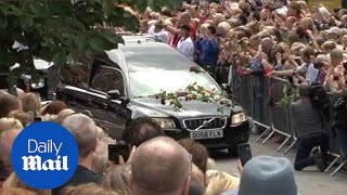 Mourners throw flowers and clap as Cilla Black makes final journey - Daily Mail