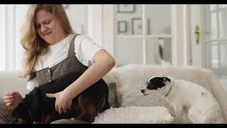 Girl Sitting On Sofa With Two Dogs L Puppy