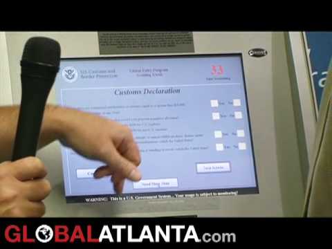 Stephen Kremer, Atlanta port director for US Customs and Border Protection, shows GlobalAtlanta reporter Trevor Williams how to use a new Global Entry kiosk at Hartsfield-Jackson Atlanta International Airport. Overseen by the Department of Homeland Security, the program that allows pre-screened international air travelers returning to the US to bypass the passport control line, saving time and hopefully keeping America safer by allowing border officers to focus on "higher-risk" passengers.