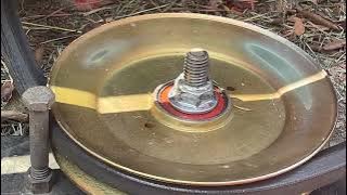 Reattaching the belt tension spring on a lawn mower