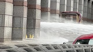 Sideways geyser of water sprays across Boston's Boylston Street