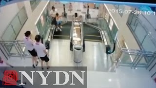 Mom in China saves child before falling through escalator