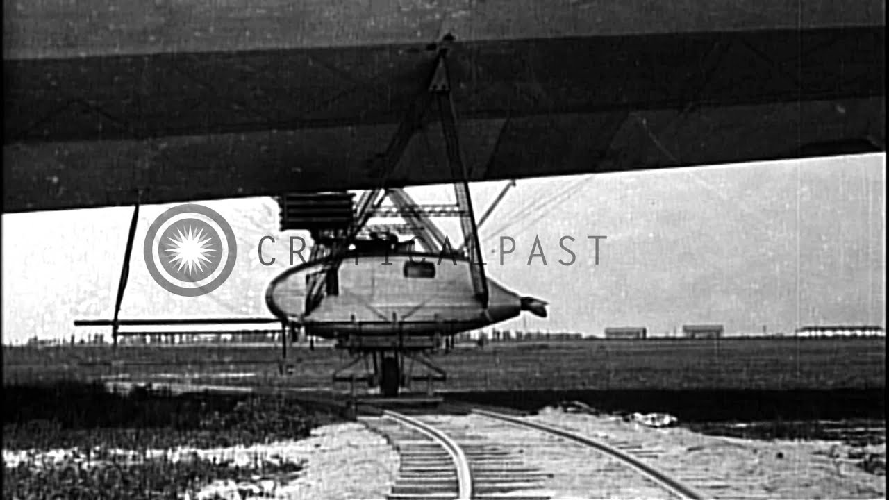 LZ-127 Graf Zeppelin in flight and LZ-126 ZR-3 airship being positioned ...