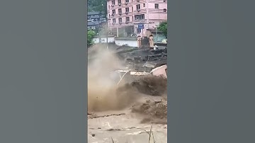 China Flood Sends Building Into River