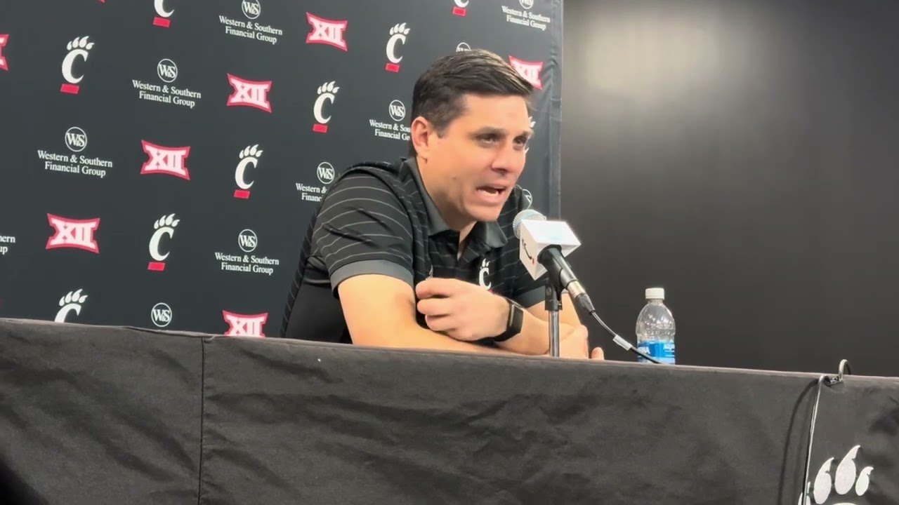 UC coach Wes Miller with Shon Abaev, Sencire Harris after NJIT 