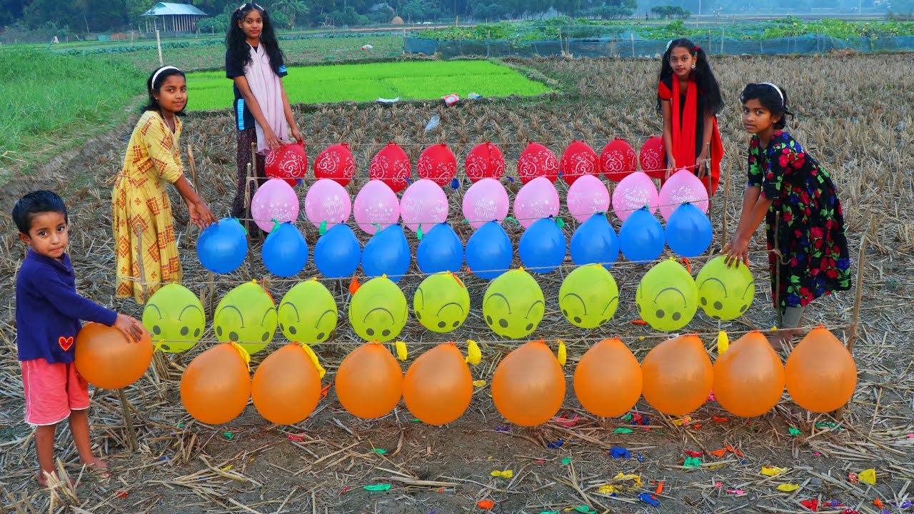 girl fun with flower balloon pop in outdoor field and learn colors for