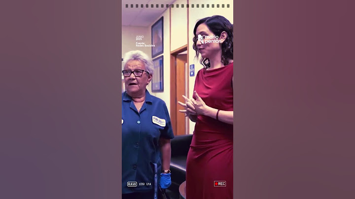 Isabel Díaz Ayuso, of Spain's Popular Party, speaks casually with a Cuban woman.