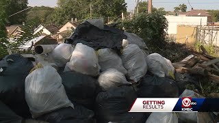 Trash pile growing in alley behind Historic Northeast Kansas City home