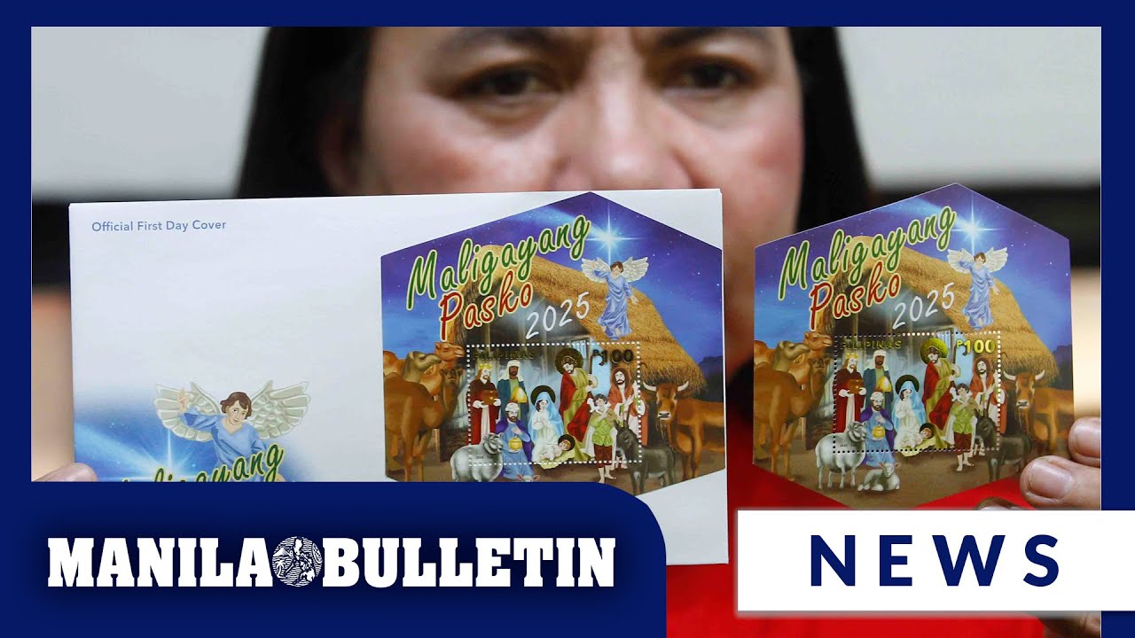 PHLPost employee displays newly issued 2025 Christmas stamps at Manila post office