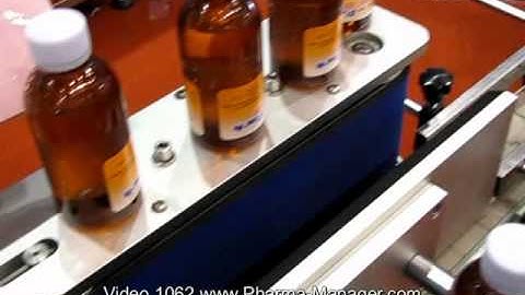 Automatic labeling machine, gluing adhesive labels on bottles. Video 1062 www.Pharma-Manager.com