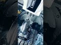 CNC machine mills curved metal component with coolant precision spray