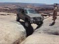 Jeep Grand Cherokee crossing Golden Crack on Golden Spike (Moab, UT)