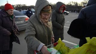 People receive humanitarian aid after fleeing besieged city of Mariupol | AFP
