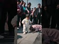 Grandma fell down, the understanding baby went forward to check and help grandma up.