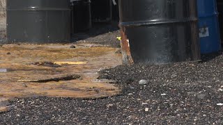 Who left sludge-leaking barrels on Stansbury Island?