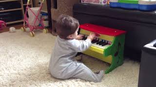 Connor playing mini piano and hailey guitar