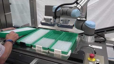 UR5 collaborative robot loading parts onto a conveyor