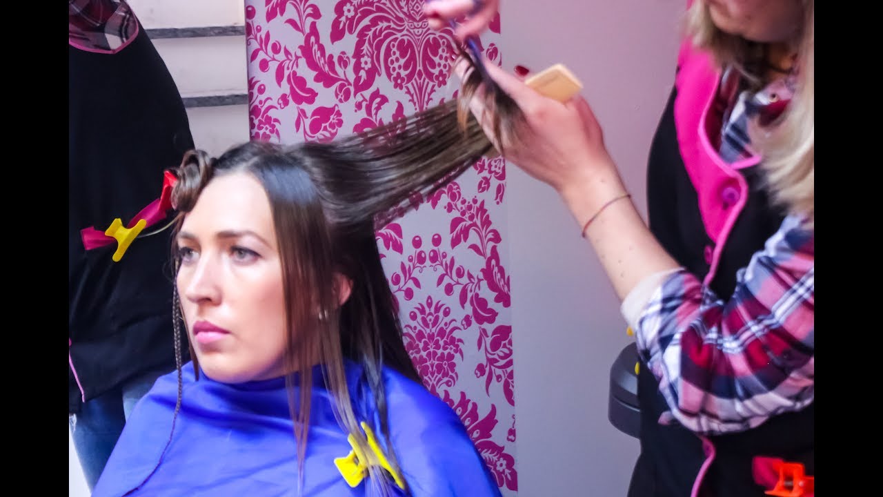 Lovely blonde young lady with long hair getting a medium, trendy, sexy and casual style