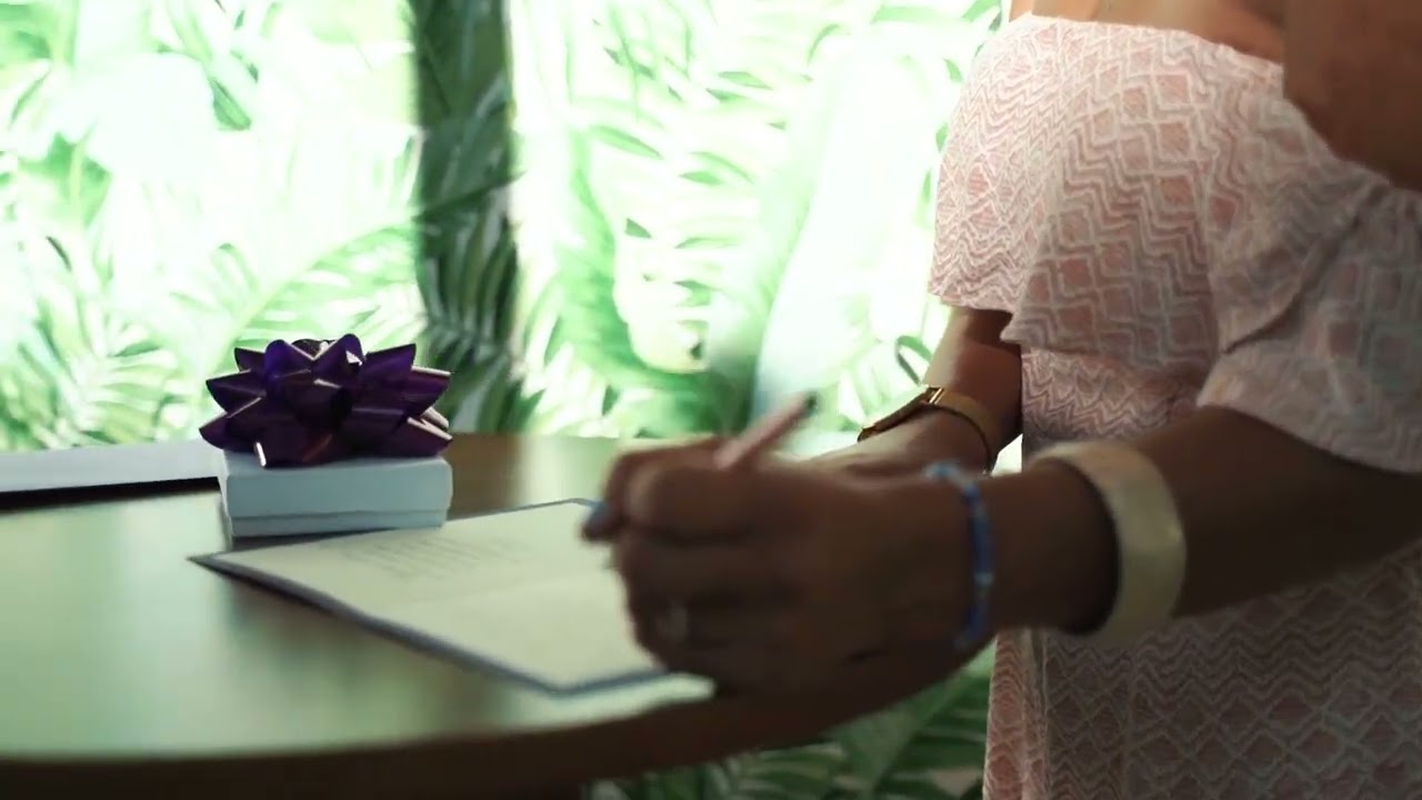 A Woman Writing A Personal Message In A Card