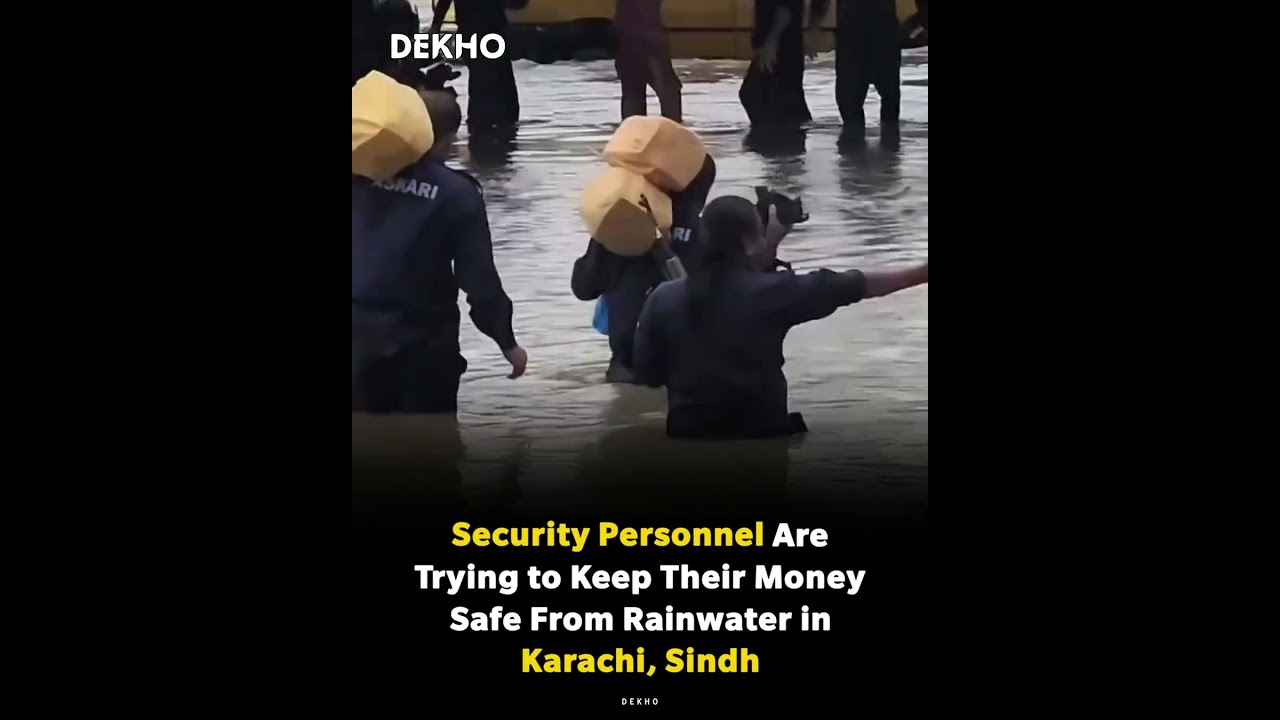 Security people are trying to keep their money safe from rainwater in Karachi 
