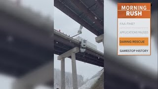 First responders rescue a driver dangling off a highway bridge