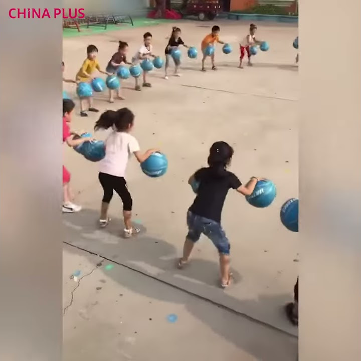 Kindergarten kids master basketball bouncing game