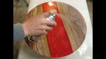 ASMR spray finishing a lazy susan made of epoxy and black walnut wood.