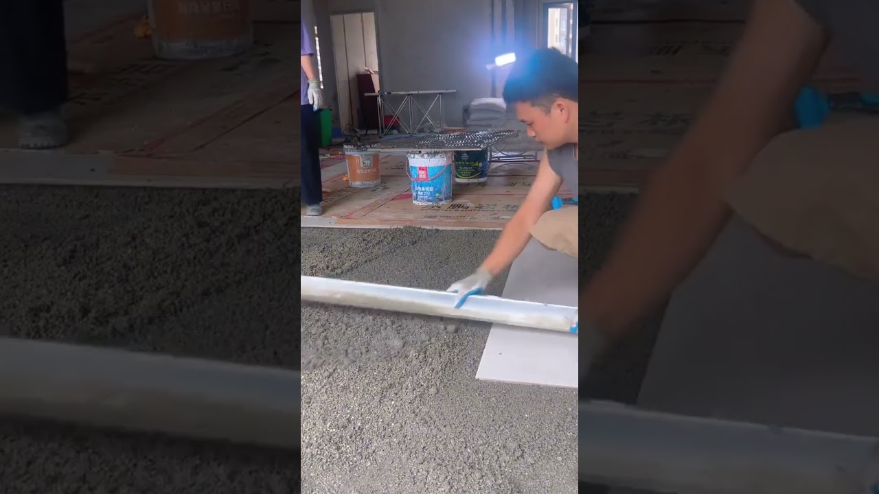 installation of large plain white ceramic tiles on the floor of a building 