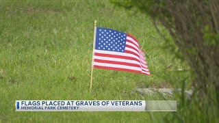 Flag planting honors fallen veterans at Memorial Park Cemetery
