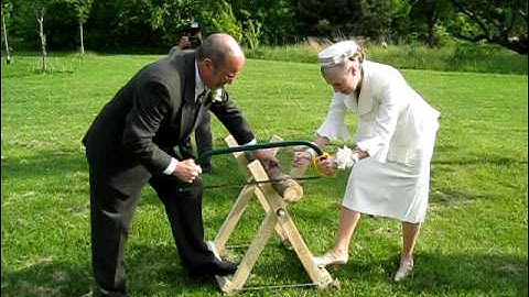 Shirley and Jim Sawing a Log