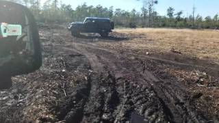 Jeep Rubicon trying to get stuck in mudd