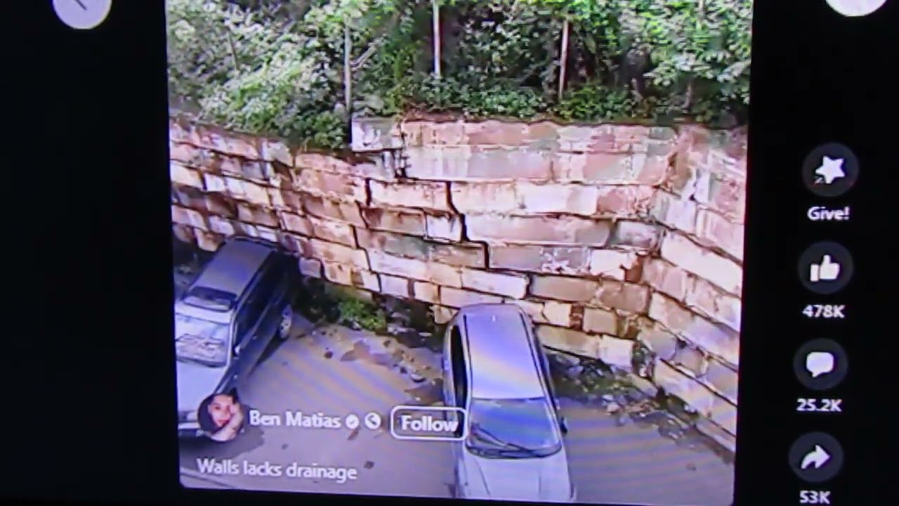 Retaining wall collapse crushes cars 