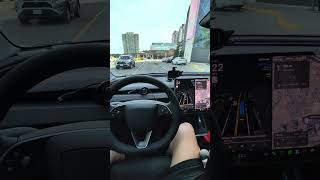 Tesla FSD navigating around Scarborough Town center parking lot going wrong way on one-way Street