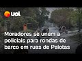 Moradores de Pelotas se unem a policiais em rondas de barco em ruas após chuvas no Rio Grande do Sul