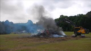 Excavator Restacking A Burn Pile