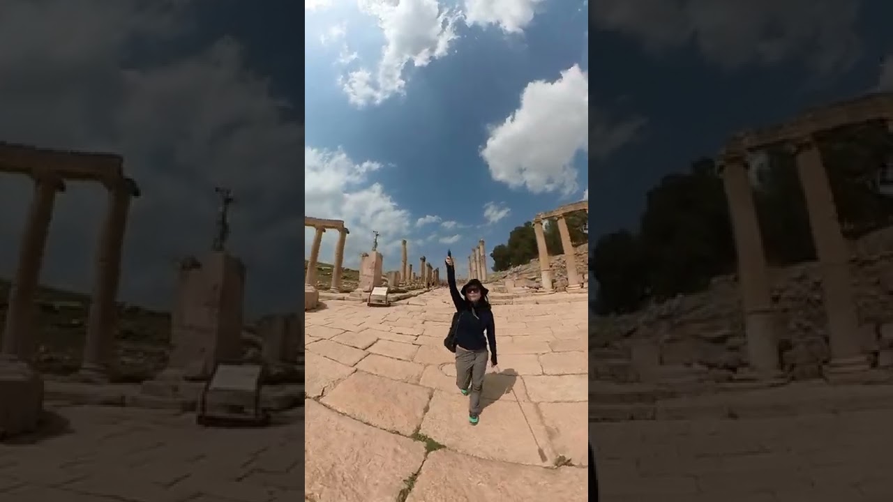 Walking down the Oval Forum of beautifully preserved Roman ruins of Jerash in Jordan 