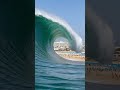 A colossal 50-metre tsunami wave towers over a crowded beach