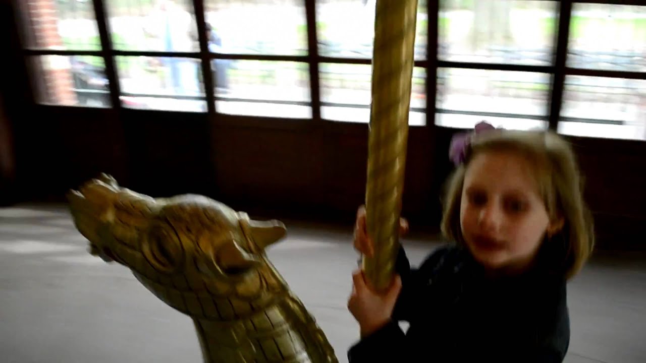 Joanna is riding Prospect Park carousel