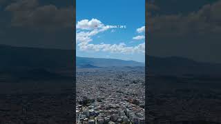 13:00 in Athens. 28°C, blue skies, soft white clouds & a view that feels straight out of a postcard.