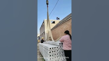 Crane Lifting Precast Concrete Slabs with Bent Metal Hooks in End Holes