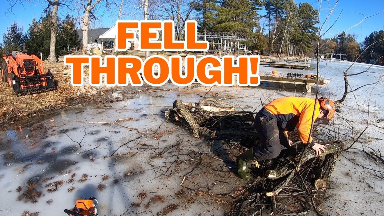 Pulling a tree off the ice with a Kubota tractor! - YouTube