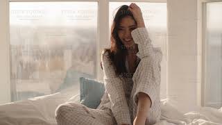Asian Woman Sitting on a Bed at Home