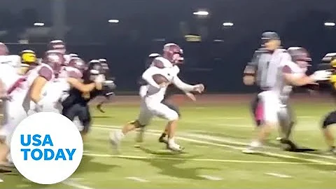 Female high school football player scores two touc...