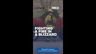Heavy snow and winds hamper firefighters in large business fire