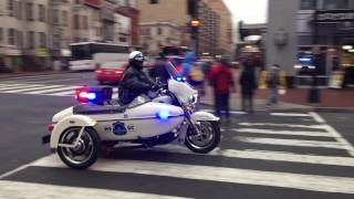 2 WASHINGTON DC METRO POLICE MOTORCYCLES & A UNITED STATES CAPITOL POLICE CRUISER ESCORTING BUSES.