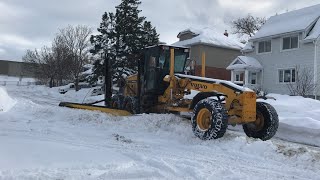 Volvo Motor Grader Plowing Snow With A Very Skilled Operator.