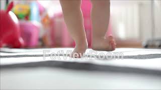 Close-Up Of A Toddlers Foot Jumping On The Carpet