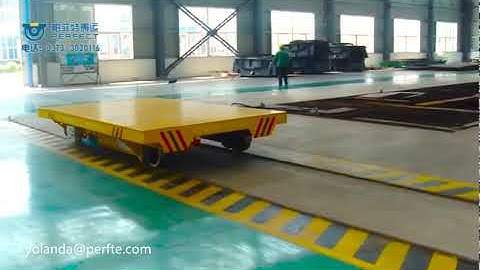 Electric flat transfer carts on rails for heavy load material handling